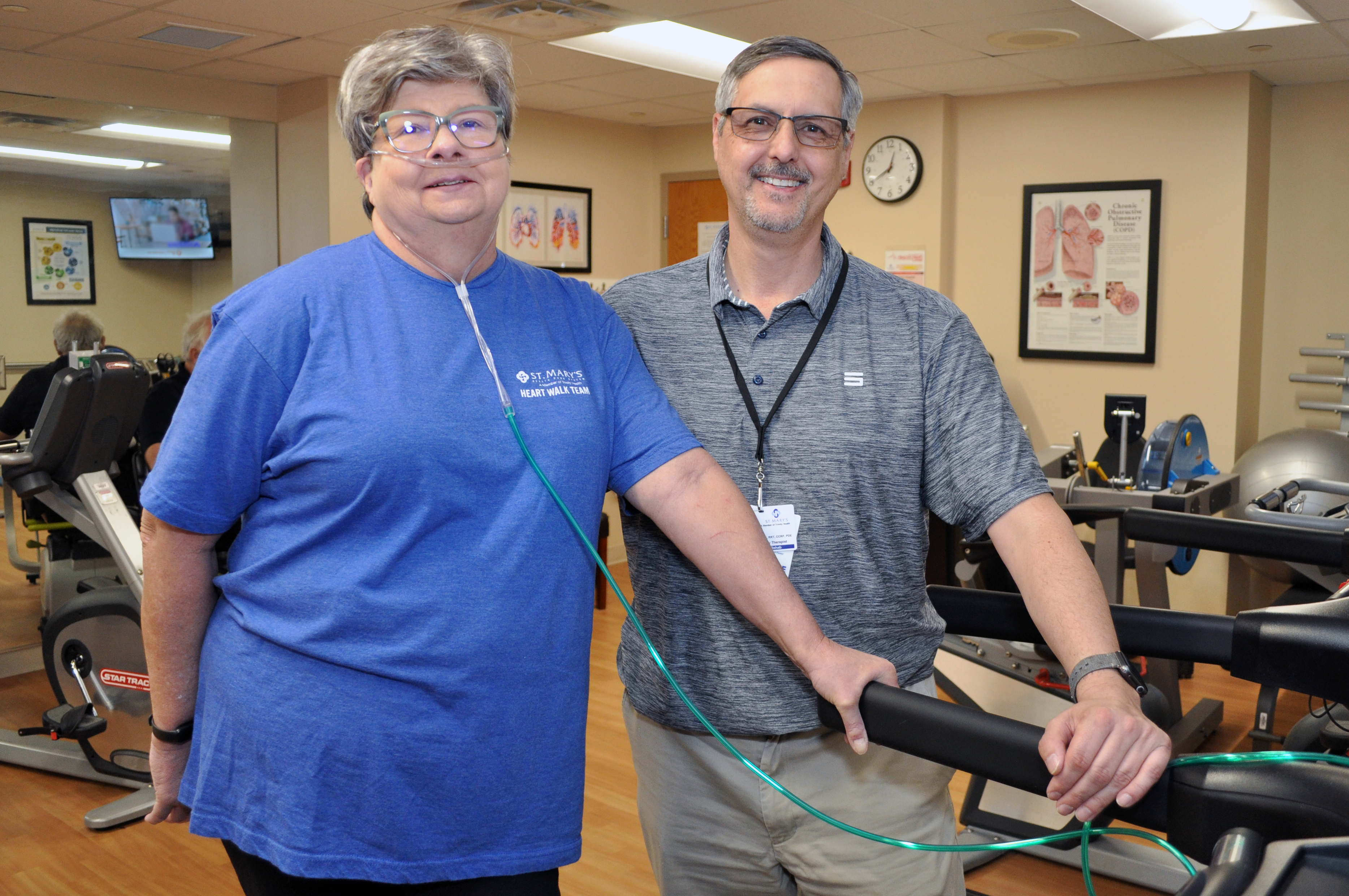 Haven Bailey takes a break from a treadmill workout in St. Mary’s Cardiac Rehabilitation gym to pose for a photo with Cardiac Rehab Coordinator Todd Drake. She was using supplemental oxygen temporarily while recovering from a respiratory infection.